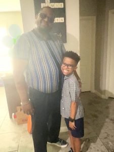 Jamie and Jayden, age 10, standing together at home, 2026.